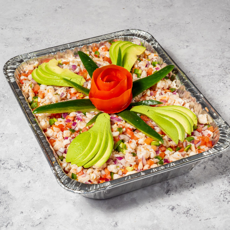 Jalisco Taqueria's shrimp ceviche in a foil tray, garnished with avocado slices and a tomato rose.